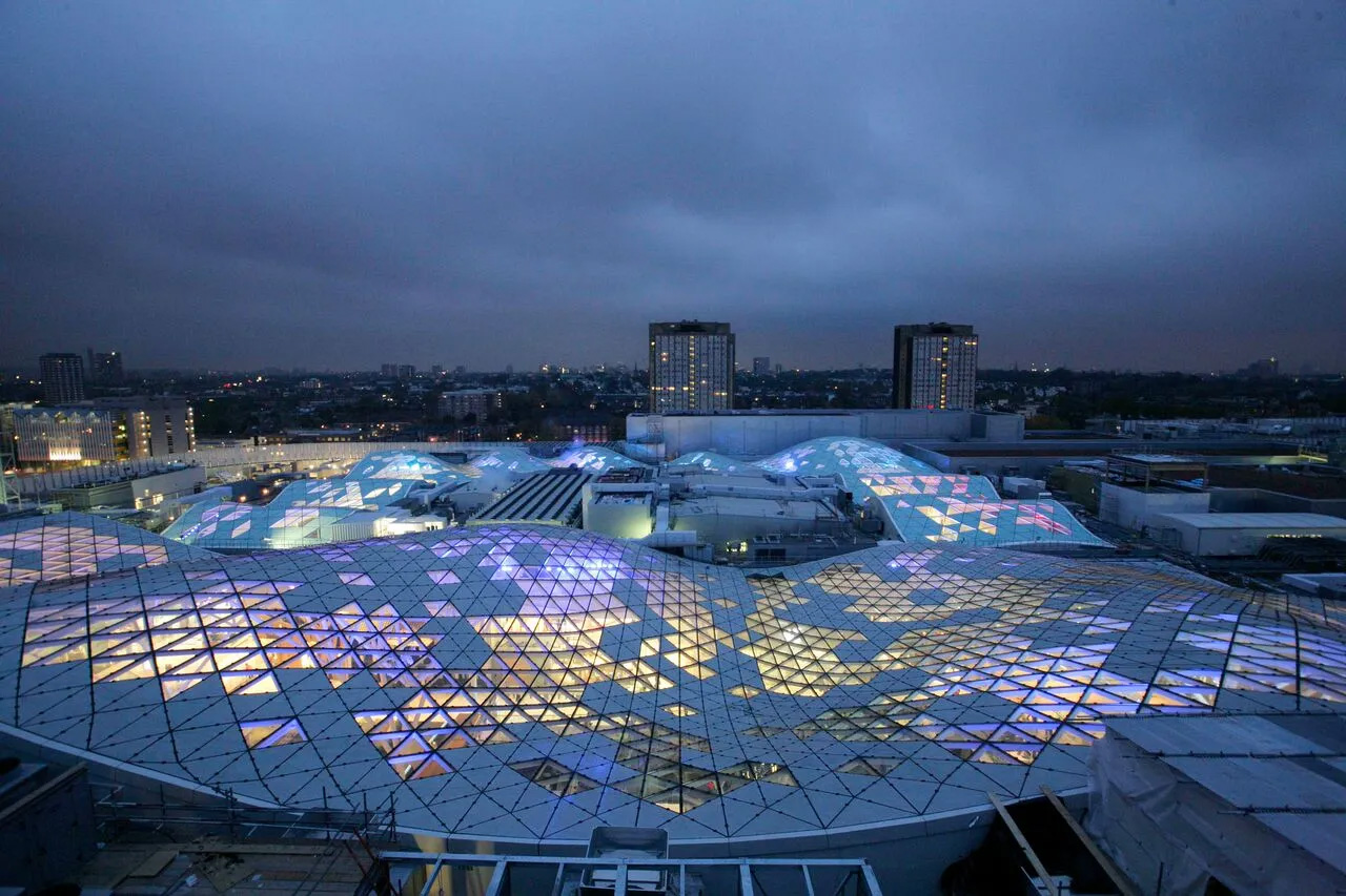 Westfield London roof lit up aerial view