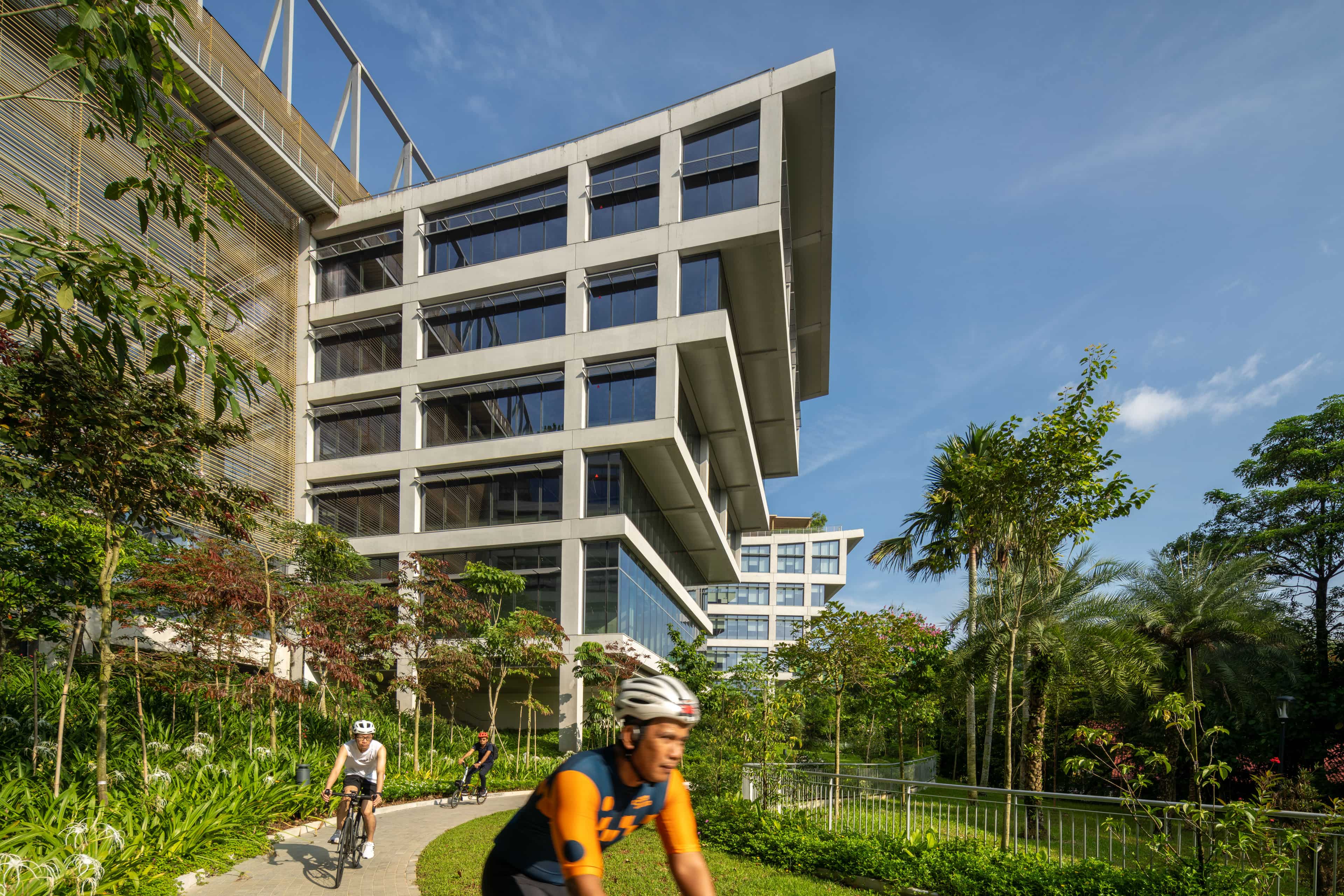 Person cycling past the SJ campus outdoor